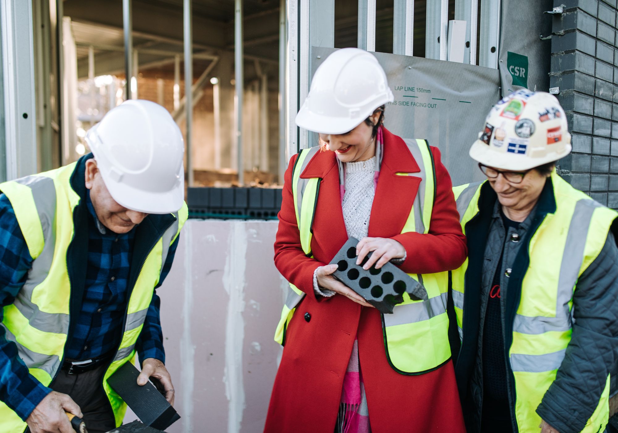 Angelina Pascale with family on building construction site